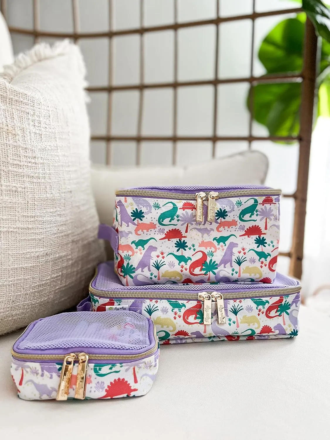 Itzy Ritzy Packing Cubes For Travel – Set of 3 Packing Cubes or Travel Organizers; Each Travel Cube Features a Mesh Top, Double Zippers and a Fabric Handle (Purple Dinosaurs)